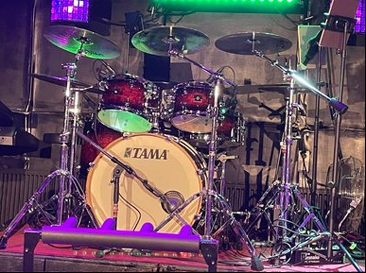 Dick Sol's Gerbman drum setup on stage with TAMA drums, Zildjian cymbals and microphones