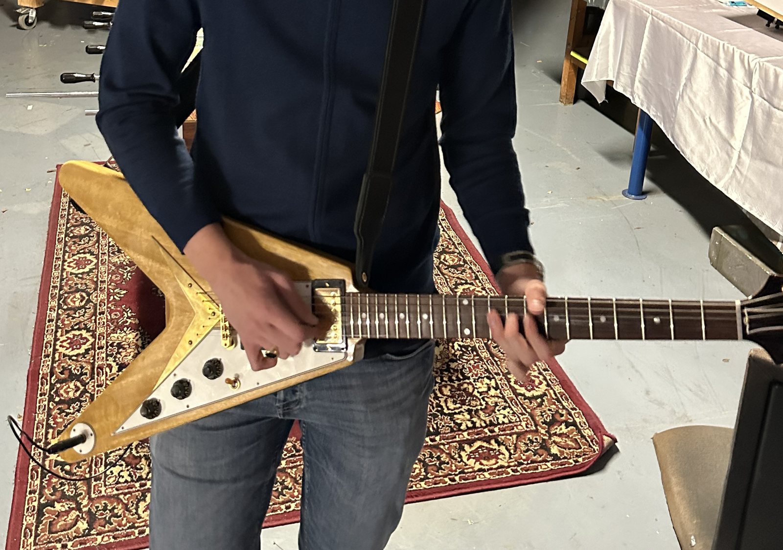 Gerbman playing his Gibson Custom Shop 1958 Korina Flying V Reissue — natural korina, white pickguard, gold hardware