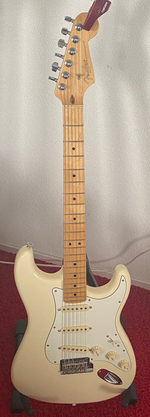 Gerbman's Fender American Professional Stratocaster in Olympic White on a stand at home — his first Stratocaster